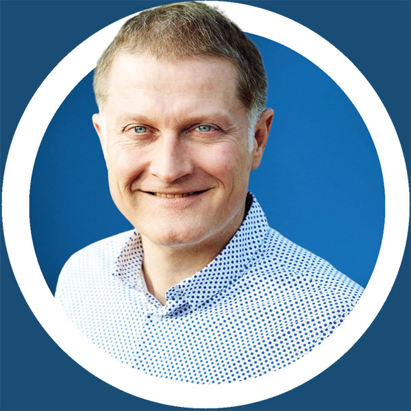 Ein Mann in einem blauen Kreis mit einem Lächeln im Gesicht.